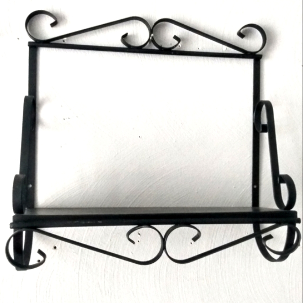 Vintage black metal shelf with scrolls